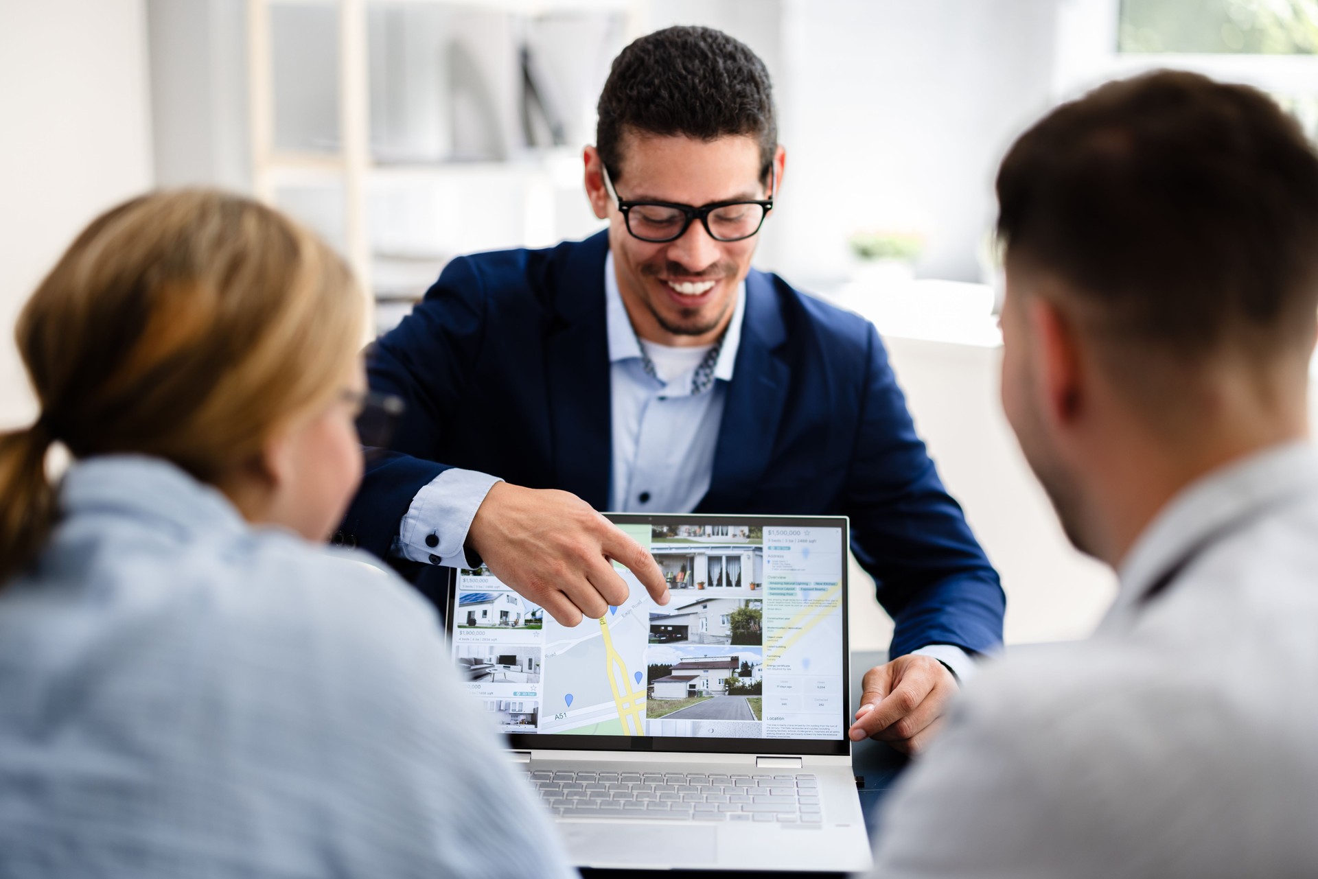 Professional Real Estate Agent Presenting Property Options to Happy Couple